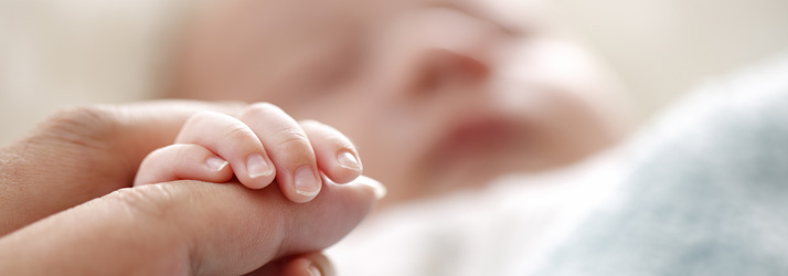 Baby-Sleeping-Holding-Caregiver-Hand